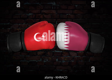 A boxing match. Confrontation between the Qatar and Turkey. Qatari, Turkish national flags on Boxing gloves. Sports competition between the two countr Stock Photo