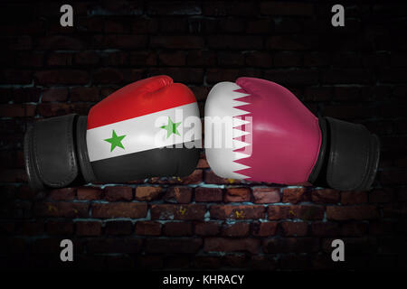 A boxing match. Confrontation between the Qatar and Syria. Qatari, Syrian national flags on Boxing gloves. Sports competition between the two countrie Stock Photo