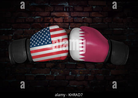 A boxing match. Confrontation between the USA and Qatar. Qatari and American national flags on Boxing gloves. Sports competition between the two count Stock Photo