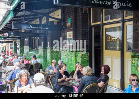 People sitting outside at the Mercantile pub hotel in The Rocks Sydney city centre enjoying an afternoon drink and a beer,Sydney,Australia Stock Photo