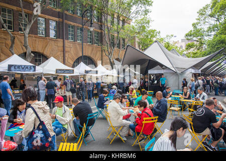 People sitting enjoying food at the outdoor saturday markets in The Rocks heritage area of Sydney,Australia Stock Photo
