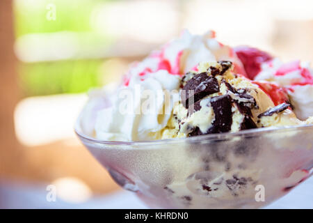 Vanilla Ice Cream Sundae In Bowl With Sauce And Dark Chocolate Stock Photo