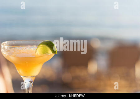 Refreshing Classic Margarita Cocktail With Lime And Salt By The Beach At Sunset On Blurred Background Stock Photo