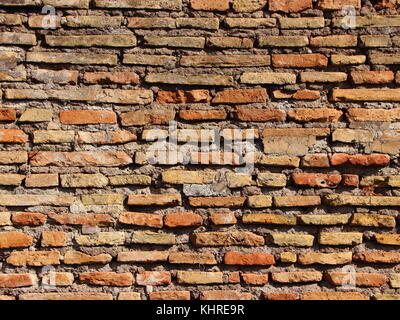 Ancient Worn Tile Brick Wall in Warm Colors Stock Photo