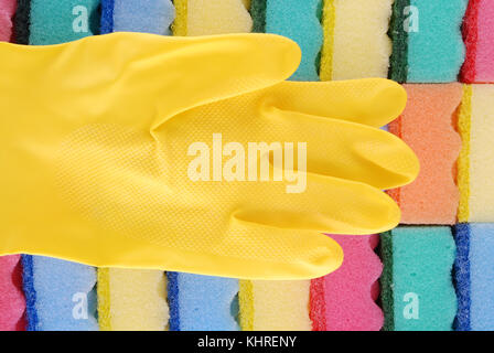Yellow rubber glove. On a background from sponges Stock Photo