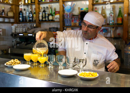 Bartender preparing poncha - traditional Madeiran alcoholic drink, Snack Bar Encumeada, Madeira, Portugal Stock Photo