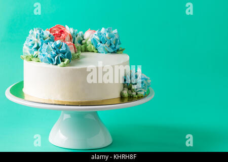 cute cake on cake stand on light green background Stock Photo