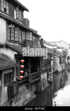 A black and white picture of the Chinese architecture and buildings lining the water canals to Xitang water town in Zhejiang Province China. Stock Photo