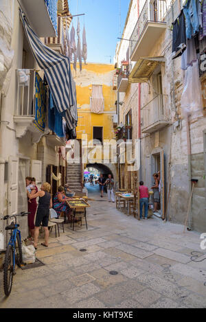 Bari, Italy - September 2, 2016: Arco Basso street in the old town of Bari. Famous street where italian women make traditional pasta called orecchiett Stock Photo