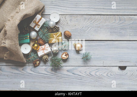 Christmas decorations in a sack on a white wooden surface Stock Photo