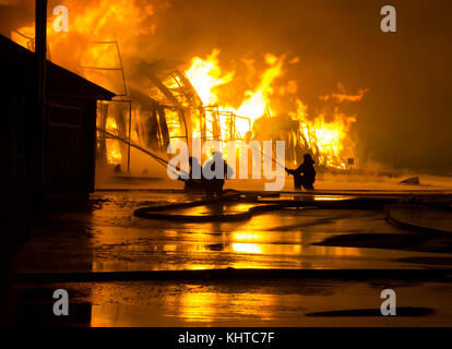Firemen at work on fire Stock Photo