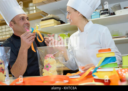 Chefs holding ribbon Stock Photo