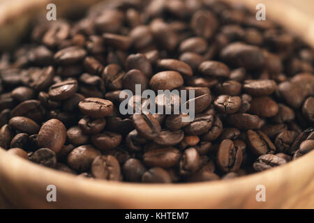 roasted coffee beans in wood bowl on table Stock Photo