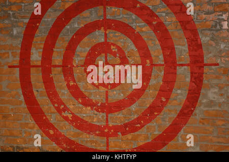 Red Target on the red brick wall. Graffiti. Stock Photo