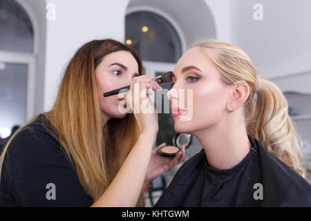 professional makeup artist doing makeup Stock Photo