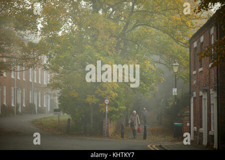 Autumn in Cheshire,  Nantwich town centre in the morning mist and fog Monks Lane a pedestrian walkway meets Market Street. Stock Photo