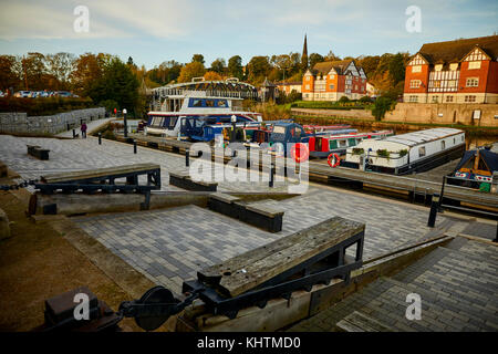 The River Weaver on the Northwich Marina featuring the oak benches that fit in with the historical loading trams of the salt industry. Autumn in North Stock Photo