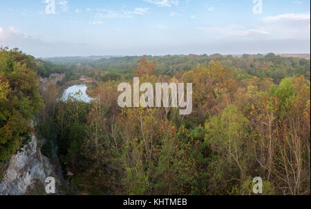 Small Lake Surrounded by Dense Forest During the Fall Season Stock Photo