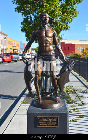 Island Spirit bronze statue of a Native American Indian holding two salmon fish in honor of the first Whidbey Islanders. Stock Photo