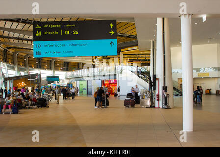 Travelers in the refurbished and modernised check in area and shopping concourse of Faro Airport in Portugal Stock Photo