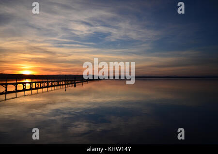 Beautiful Sunset over lake with Jetty, Tuggerah Lake NSW Australia Stock Photo