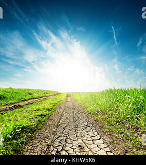 sunset in blue sky over drought earth Stock Photo