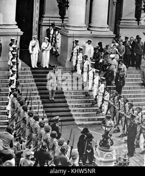 Photograph of King George VI and Queen Elizabeth Queen Mother leaving the Parliament House in South Africa after opening the session, speaking in both English and Afrikaans. George VI (1895-1952) King of the United Kingdom and the Dominions of the British Commonwealth, the last Emperor of India and the first Head of the Commonwealth. Queen Elizabeth The Queen Mother (1900-2002). Dated 20th Century Stock Photo