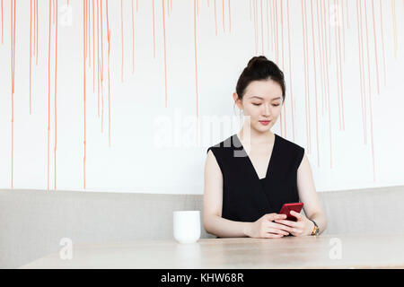 Woman having coffee break with phone Stock Photo