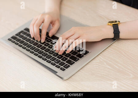 Woman typing on laptop keyboard Stock Photo
