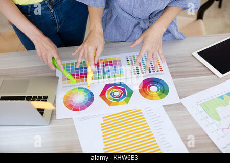 Colleagues working with colour charts and graphs Stock Photo - Alamy