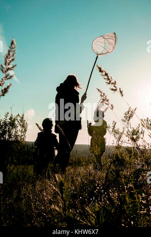 Mother and children with butterfly net, Ural, Sverdlovsk, Russia Stock Photo