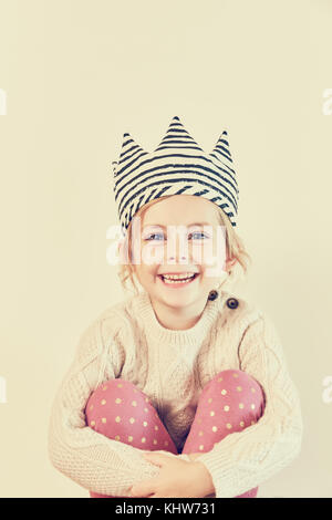 Portrait of a girl hugging her knees Stock Photo - Alamy