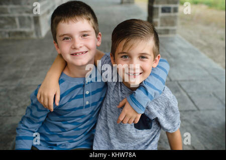 Brothers with arms around each other Stock Photo