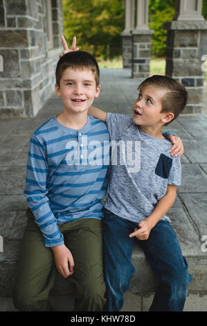 Brothers with arms around each other Stock Photo