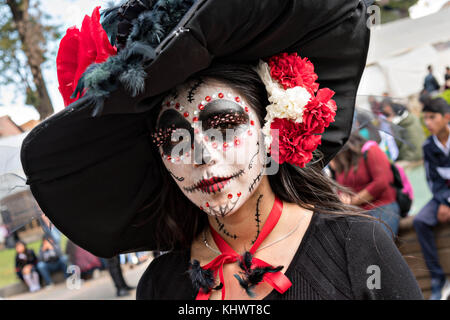 A young woman dressed in La Calavera Catrina costume for the Day of the Dead or Día de Muertos festival October 31, 2017 in Patzcuaro, Michoacan, Mexico. The festival has been celebrated since the Aztec empire celebrates ancestors and deceased loved ones. Stock Photo
