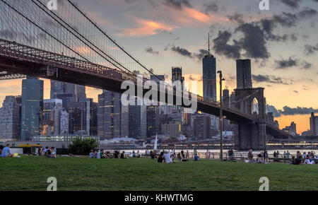 New York, NY, USA - July 3, 2017. People enjoying the view of Manhattan from Brooklyn Bridge Park