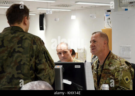 U.S. Army Brig. Gen. Jeffrey Smiley (RT), Commanding General of the 40th Infantry Division, California Army National Guard, discusses the situational battlefield during the daily command update brief during exercise Allied Spirit VII at the U.S. Army's Joint Multinational Readiness Center in Hohenfels, Germany Nov. 17, 2017. Approximately 4,050 service members from 13 nations are participating in exercise Allied Spirit VII at 7th Army Training Command’s Hohenfels Training Area, Germany, Oct. 30 to Nov. 22, 2017. Allied Spirit is a U.S. Army Europe-directed, 7ATC-conducted multinational exercis Stock Photo