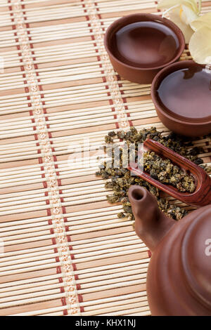 Chinese green tea, ceramic teapot, two tea cups on a wooden background. view from above Stock Photo