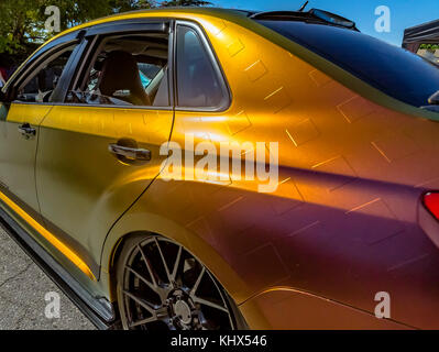 Metallic orange car from the back driver's side passenger. Custom cars in Southern California summer 2017 Stock Photo