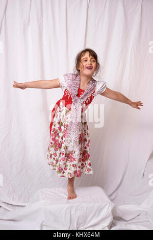 Seven year old girl from Germany posing with a bavarian style costume and shawl. Stock Photo