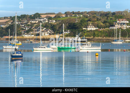 Sailing craft boats moored in Falmouth Harbour with Flushing Village in the background Falmouth Cornwall UK. Stock Photo