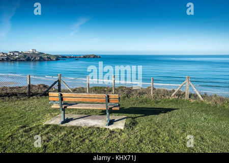 An empty bench seat overlooking Newquay Bay at Barrowfields in Newquay Cornwall UK. Stock Photo