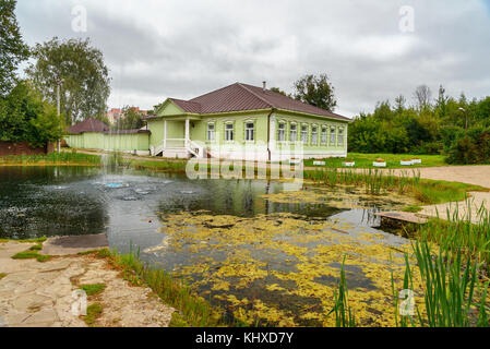 View of pond and wooden house museum of the 19th century in Dmitrov Kremlin. Dmitrov. Moscow region. Russia Stock Photo