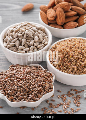 Homemade LSA mix in plate and Linseed or flax seeds, Sunflower seeds and Almonds. Traditional Australian blend of ground, source of dietary fiber, pro Stock Photo