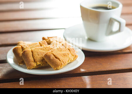Sweet cookies and coffee cup on garden table. Stock Photo