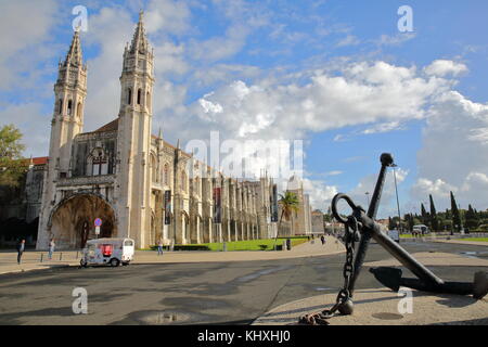 LISBON, PORTUGAL - NOVEMBER 3, 2017: Exterior facade of Jeronimos Monastery and Maritime Museum entrance with a ship anchor in the foreground Stock Photo