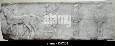 Greek Art. Base of funerary Kouros. Four-horse chariot and hoplites. 510-500 BC. Relief. Found in the Kerameikos, built into the Themistokleian wall. National Archaeological Museum of Athens, Stock Photo