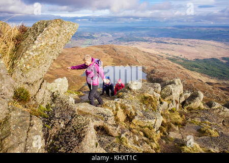 Hikers climbing on the Daear Ddu east ridge scramble on Carnedd Moel Siabod mountain in mountains of Snowdonia National Park. Capel Curig Wales UK Stock Photo