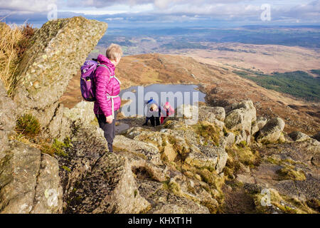 Hikers climbing on Daear Ddu east ridge scramble on Carnedd Moel Siabod mountain in mountains of Snowdonia National Park. Capel Curig Conwy Wales UK Stock Photo