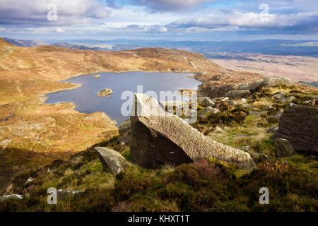 View to Llyn Y Foel lake in Cwm Y Foel from Daear Ddu east ridge on Carnedd Moel Siabod mountain in mountains of Snowdonia National Park. Wales UK Stock Photo